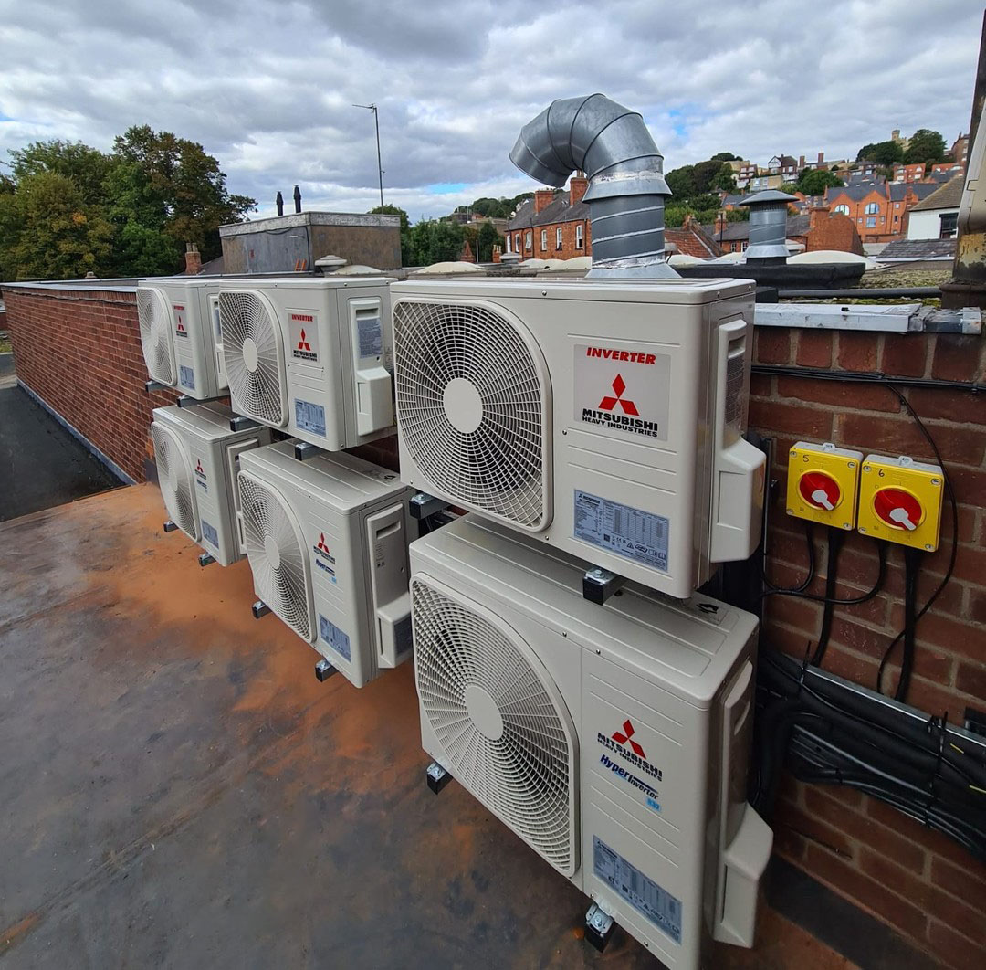 Mitsubishi air conditioning units on top of building.